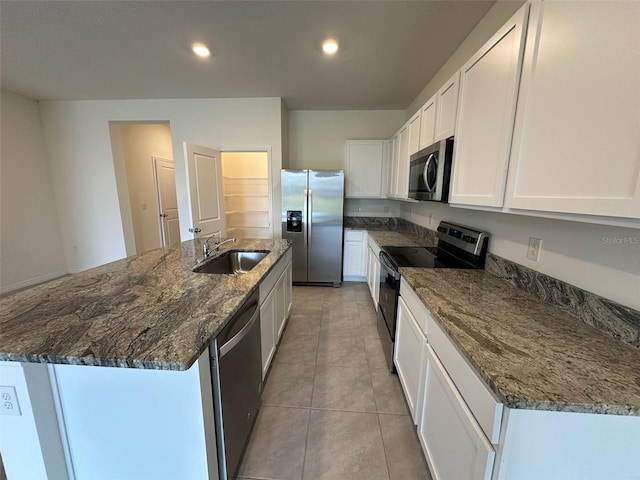 kitchen with white cabinets, sink, a kitchen island with sink, and appliances with stainless steel finishes