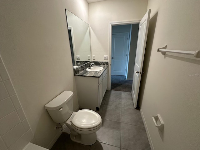 bathroom featuring tile patterned floors, vanity, and toilet