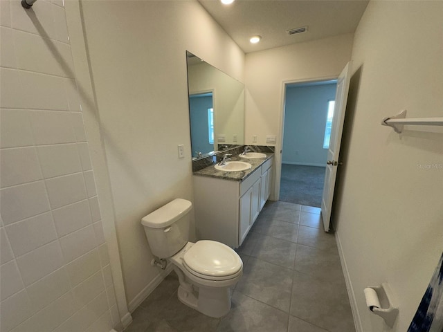 bathroom featuring tile patterned floors, vanity, and toilet