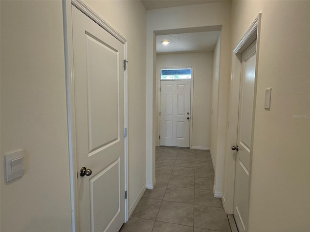 corridor featuring light tile patterned flooring