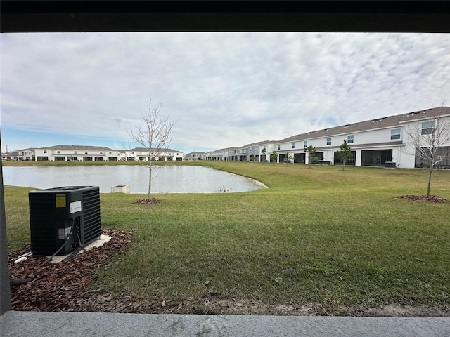 view of yard featuring a water view and cooling unit