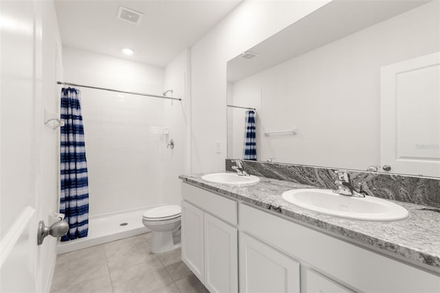 bathroom featuring toilet, vanity, tile patterned floors, and a shower with shower curtain