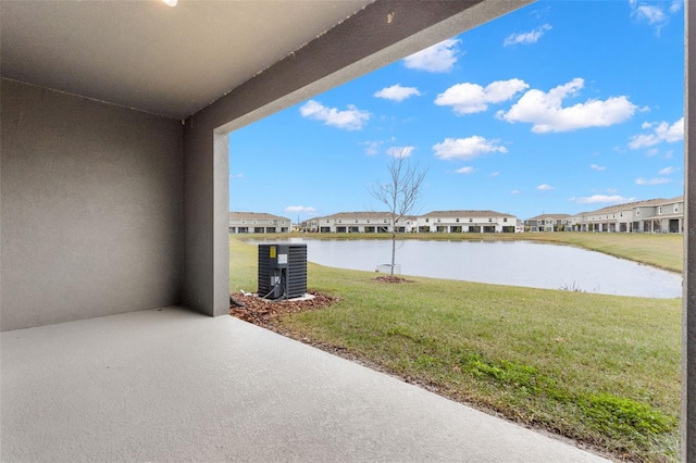 exterior space with a water view, central AC unit, and a patio area