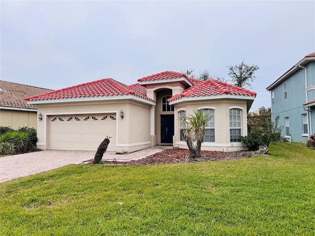 mediterranean / spanish-style house with a front lawn and a garage