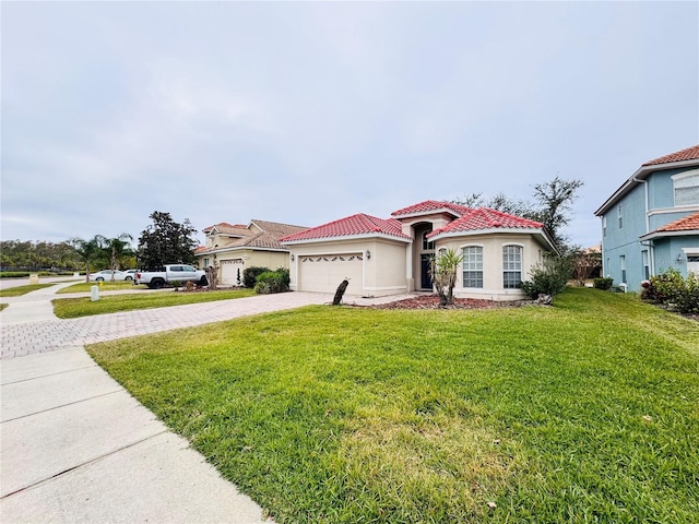 mediterranean / spanish house with a front yard and a garage