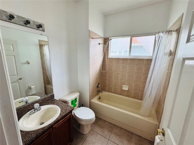 full bathroom with tile patterned floors, shower / bath combo with shower curtain, vanity, and toilet