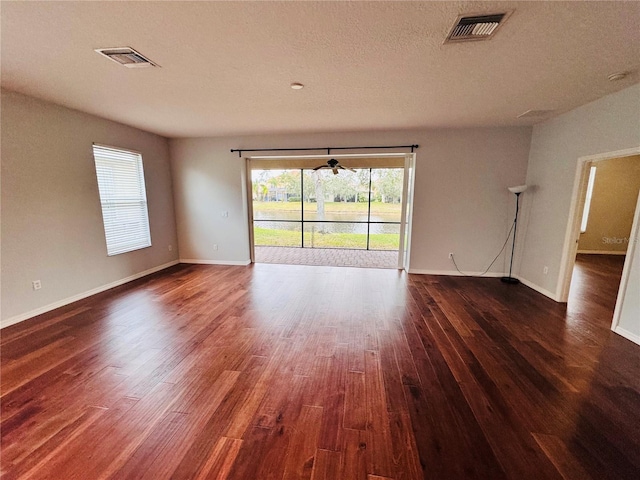 spare room featuring ceiling fan and dark hardwood / wood-style floors