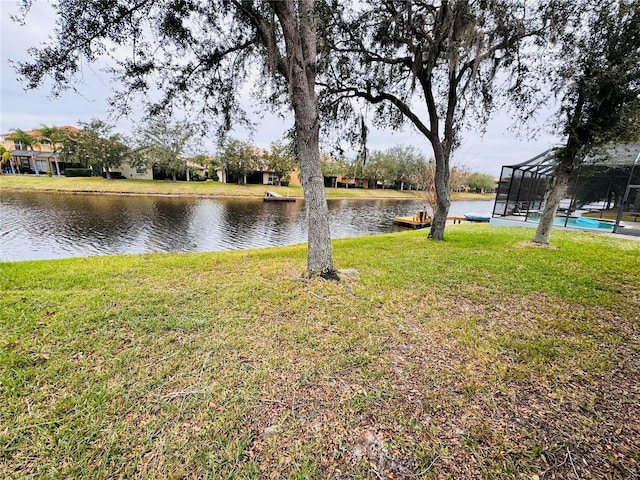 view of yard featuring a water view and a lanai