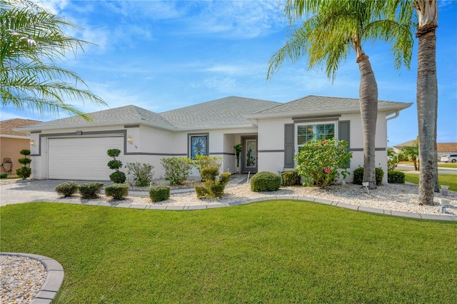 view of front of property featuring a front yard and a garage