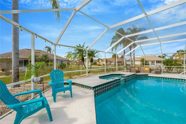 view of swimming pool with an in ground hot tub, a patio, and glass enclosure