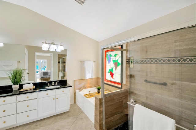 bathroom with tile patterned flooring, vanity, plus walk in shower, and vaulted ceiling