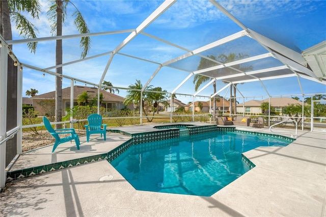 view of swimming pool featuring an in ground hot tub, a patio, and a lanai