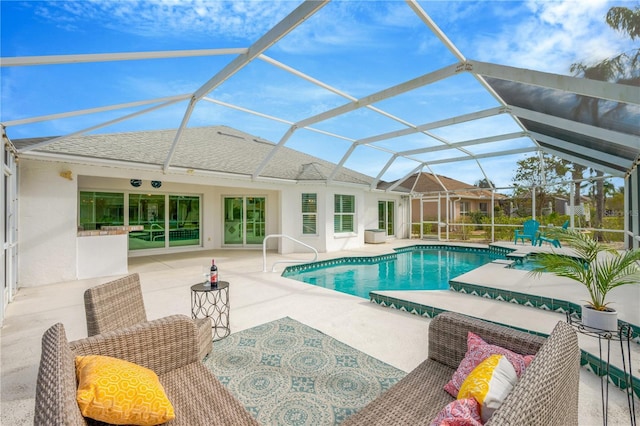 view of pool featuring a lanai, a patio area, and outdoor lounge area