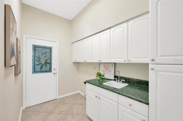 clothes washing area with light tile patterned floors and sink