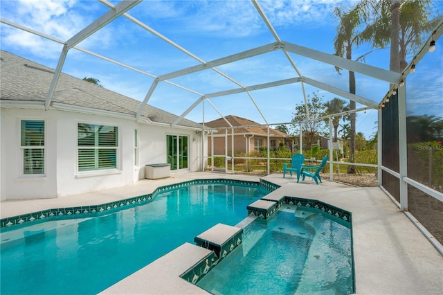 view of swimming pool featuring a patio and a lanai