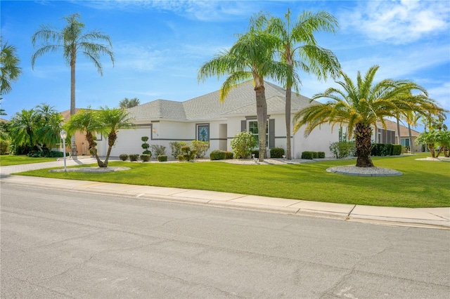 view of front facade with a garage and a front lawn