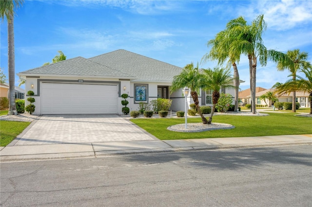 view of front of house with a front lawn and a garage