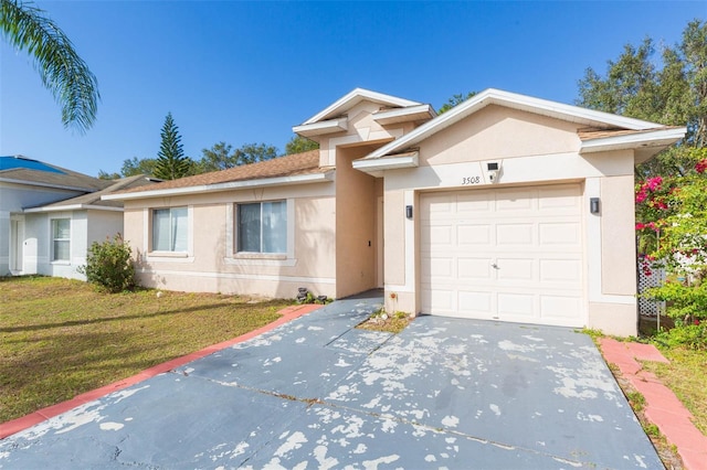 ranch-style home featuring a garage and a front lawn