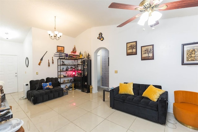 living room with ceiling fan with notable chandelier, light tile patterned flooring, and vaulted ceiling