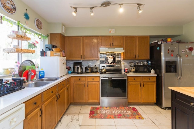 kitchen with decorative backsplash, appliances with stainless steel finishes, a healthy amount of sunlight, and sink