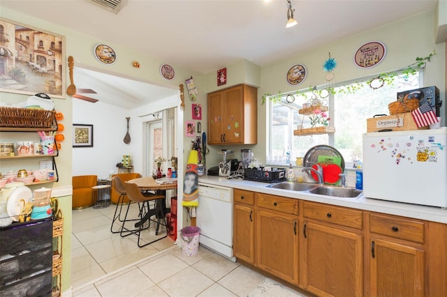 kitchen with light tile patterned floors, white appliances, ceiling fan, and sink