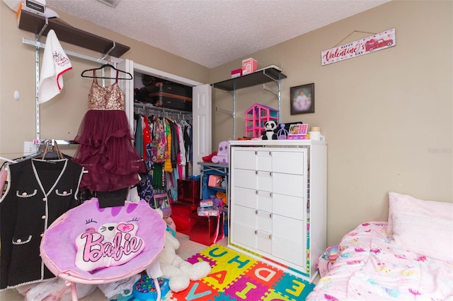 bedroom with a textured ceiling and a closet