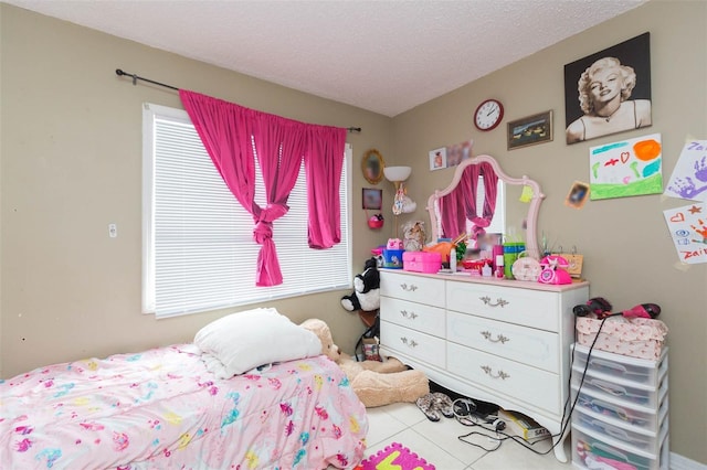 tiled bedroom with a textured ceiling