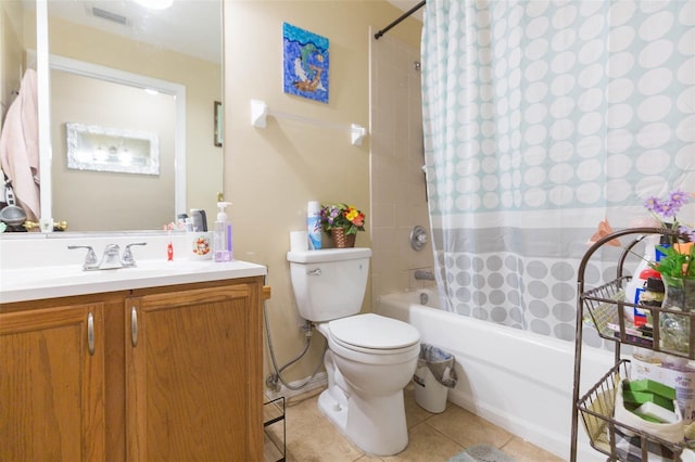 full bathroom featuring vanity, shower / bath combo with shower curtain, tile patterned flooring, and toilet