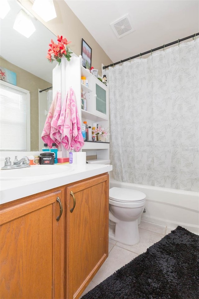 full bathroom featuring tile patterned flooring, vanity, toilet, and shower / bath combo