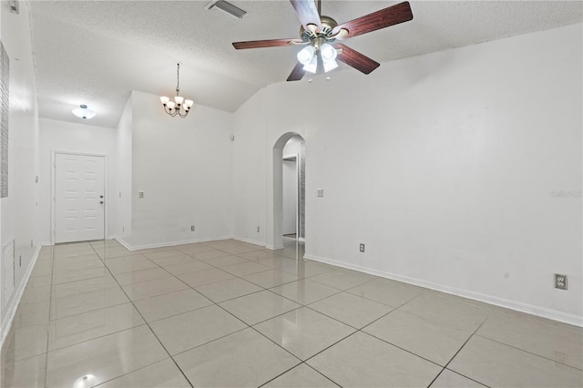 unfurnished room with light tile patterned floors, visible vents, arched walkways, and a textured ceiling