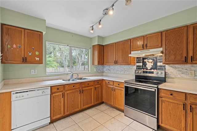 kitchen featuring white dishwasher, stainless steel electric range, light countertops, under cabinet range hood, and a sink