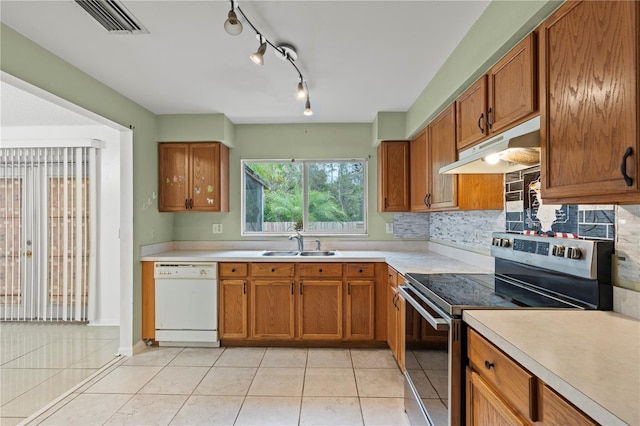 kitchen featuring electric stove, light countertops, a sink, dishwasher, and under cabinet range hood