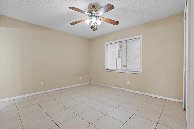 unfurnished room with a ceiling fan, a textured ceiling, and baseboards