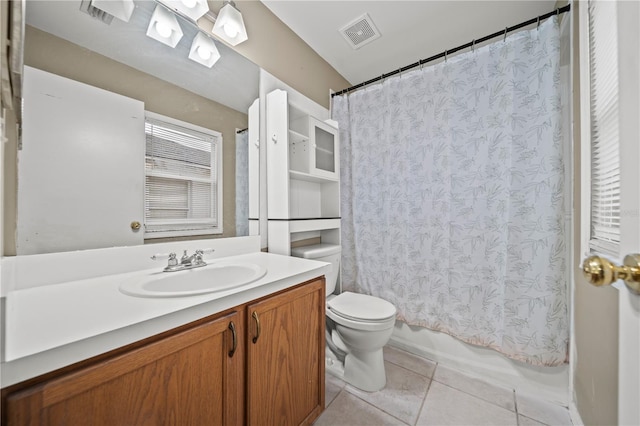 bathroom with toilet, shower / tub combo, vanity, visible vents, and tile patterned floors