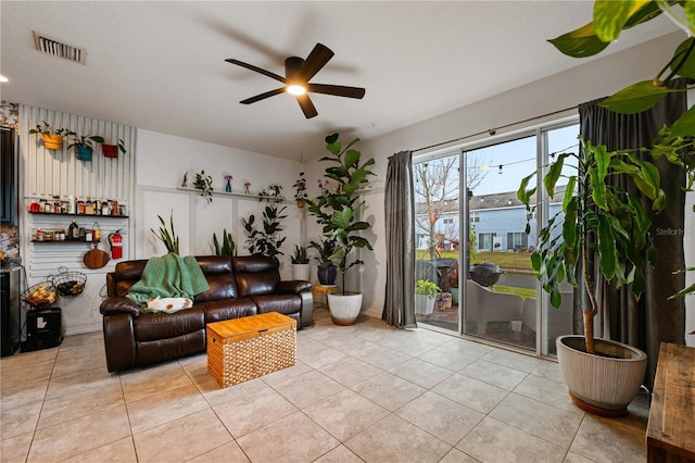 living room with light tile patterned floors and ceiling fan