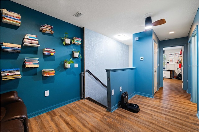 interior space featuring wood-type flooring and a textured ceiling