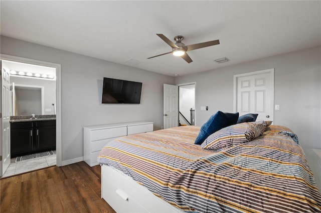 bedroom with sink, dark wood-type flooring, ceiling fan, and ensuite bathroom