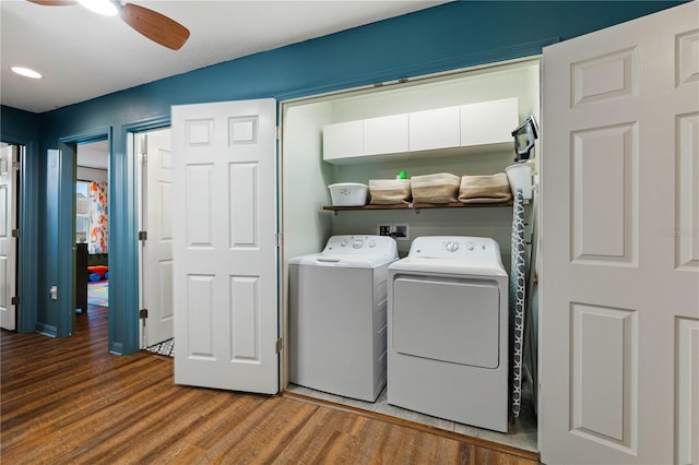 laundry area featuring wood-type flooring, washer and dryer, and ceiling fan