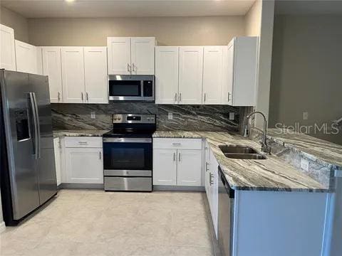 kitchen featuring appliances with stainless steel finishes and white cabinetry