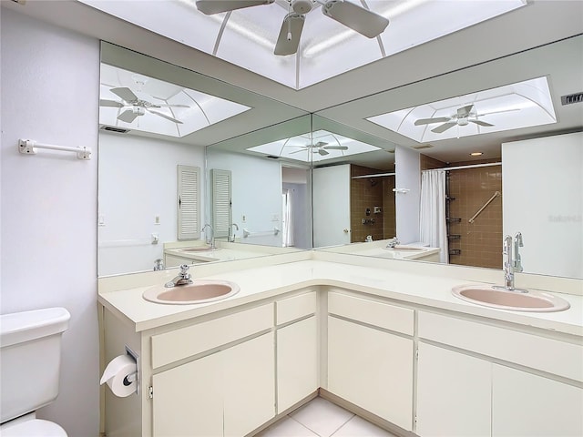 full bathroom featuring tile patterned flooring, vanity, toilet, and shower / tub combo with curtain