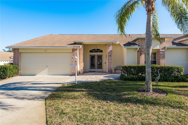 single story home with a garage and a front lawn