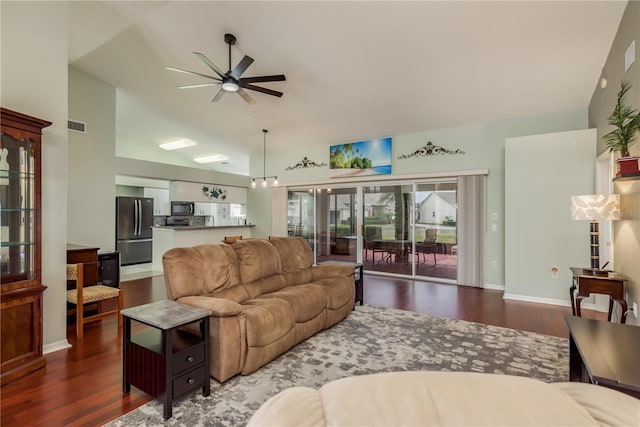 living room with lofted ceiling, ceiling fan, and dark hardwood / wood-style floors