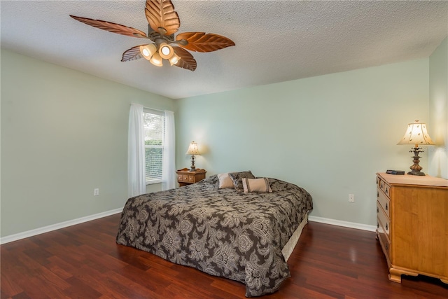 bedroom featuring a textured ceiling, dark hardwood / wood-style flooring, and ceiling fan