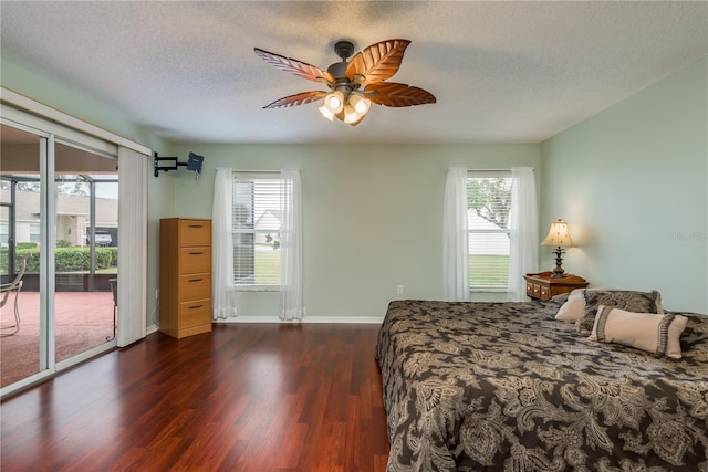 bedroom with ceiling fan, a textured ceiling, access to outside, and multiple windows