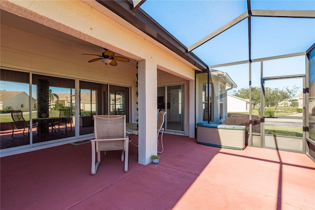 view of patio / terrace featuring ceiling fan and a lanai