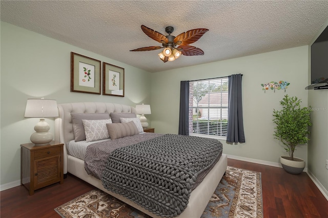 bedroom with ceiling fan, dark hardwood / wood-style floors, and a textured ceiling