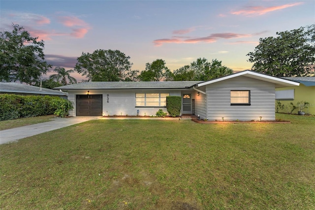 single story home with a yard and a garage