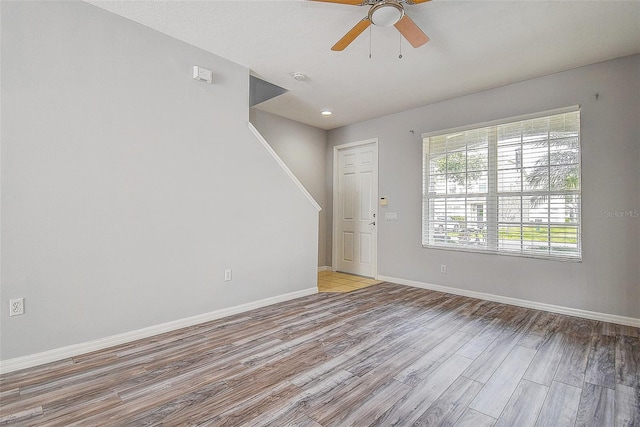 empty room featuring ceiling fan and light hardwood / wood-style flooring