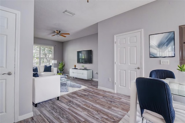 office space with ceiling fan and light hardwood / wood-style floors