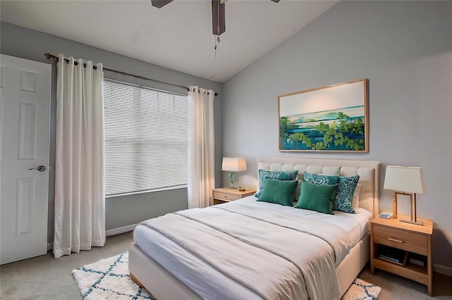 bedroom with ceiling fan, light colored carpet, and vaulted ceiling